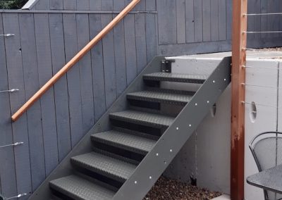 metal stairs leading from garden to patio