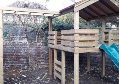Children's wooden playhouse with monkey bars