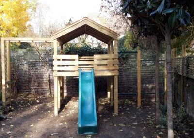 front view of garden playhouse with blue slide