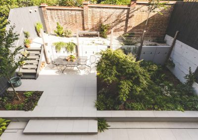 ariel view of garden with patio of white flagstones and grey steps