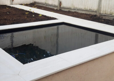 rectangle water feature surrounded by plant beds