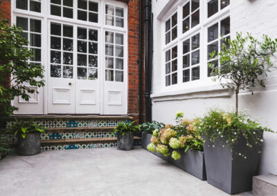 encaustic tiles on steps and grey tiles in back garden