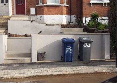 black and blue bins in front of terraced house with steep steps