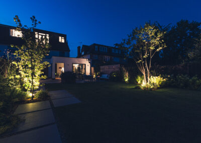 Garden lit with lamps at night